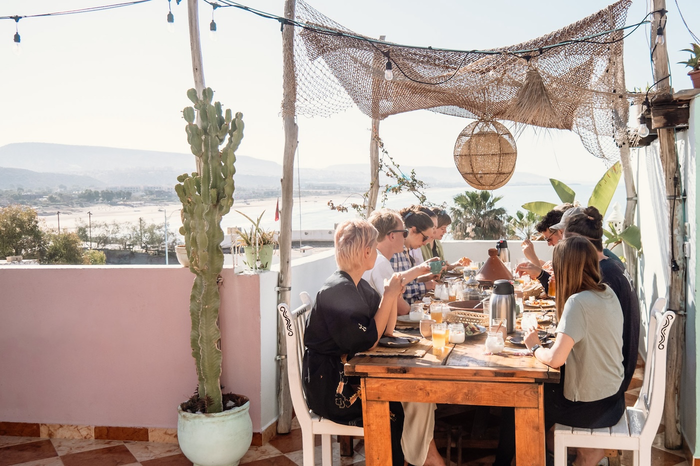 Diners sat around the table for a meal at Amayour Surf & Yoga Retreat