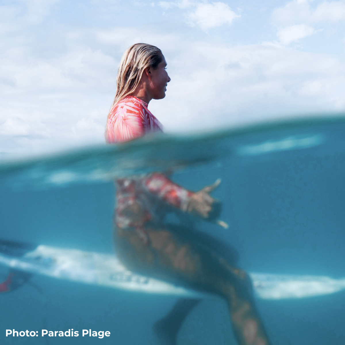A girl surfing at Paradis Plage